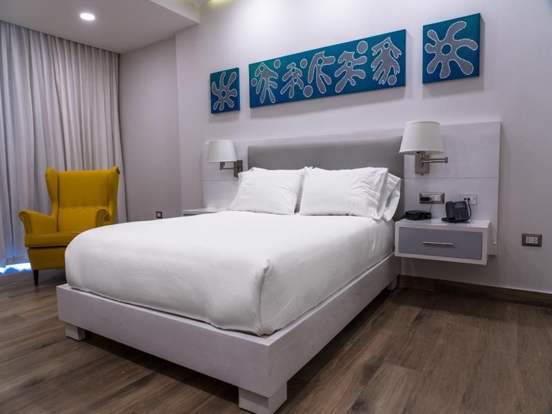Guest room with a yellow armchair