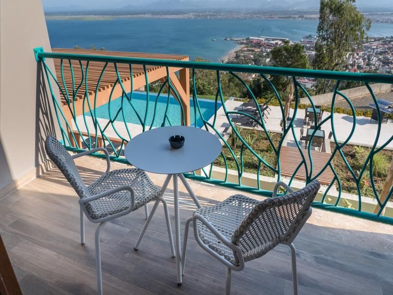 Balcony with table and chairs above the pool