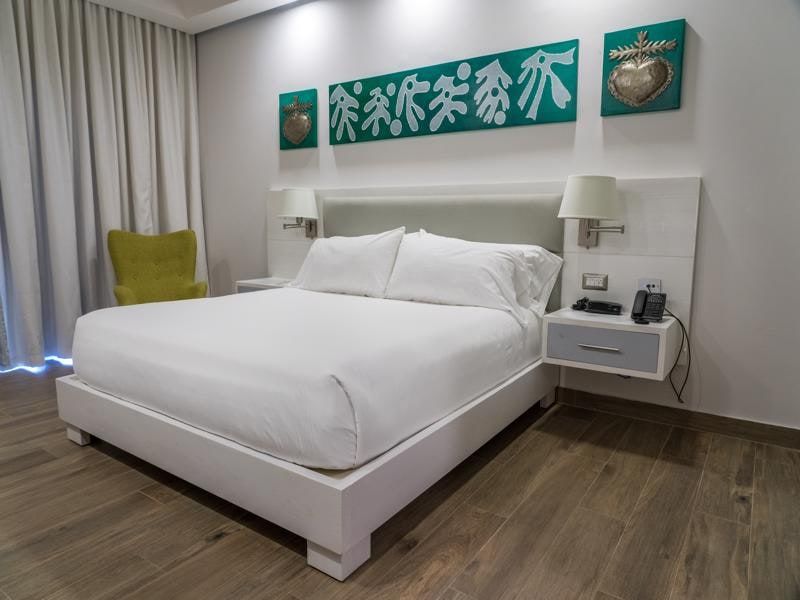 King bed with a green accent chair