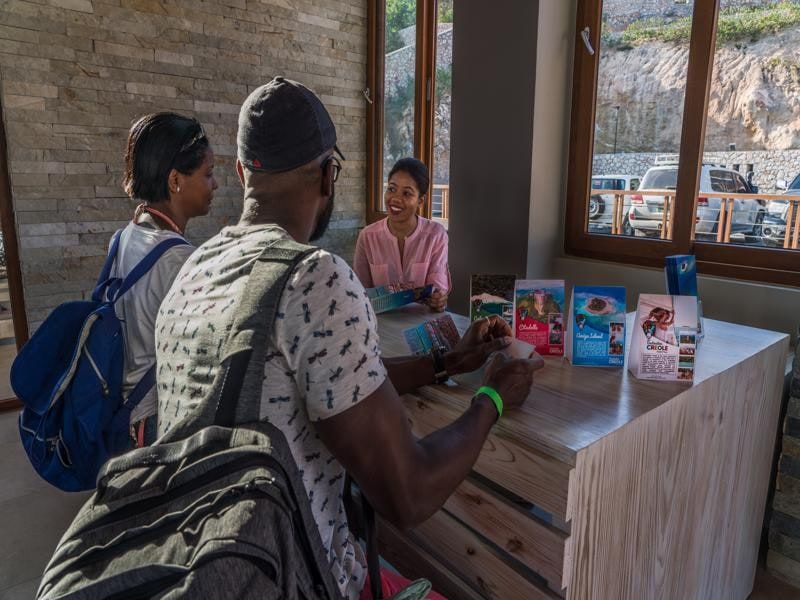 Guests planning excursions at the tour desk