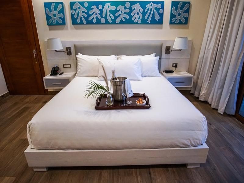 King bed with Haitian-inspired wall art