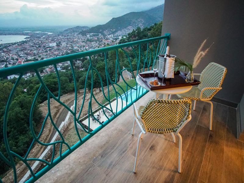 Private balcony with chairs and a view over the city