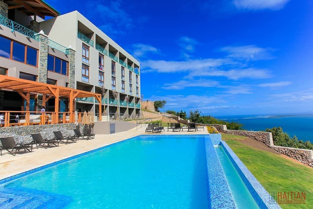 Infinity pool with sun loungers, overlooking the sea